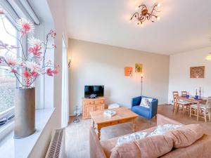 a living room with a couch and a table at Koeienstal in Hooge Zwaluwe