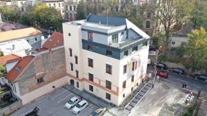 an overhead view of a white building in a city at Ophir Apartment Ultracentral,the greenest and brightest central area,3 parking space in the large yard in Cluj-Napoca