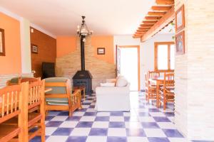 a living room with a fireplace and a checkered floor at Casa Levante - Casa Rural Los Cuatro Vientos in Moratalla