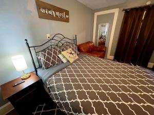 a bedroom with a bed and a table with a lamp at Private Studio- Queen Bed- 10 min to DT Indy in Indianapolis