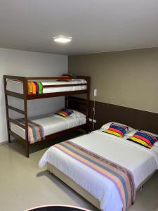 two bunk beds in a room withthritisthritislictslictslicts at Hotel Tunebo Inn in Ríohacha