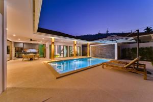 an indoor swimming pool in a house at night at New Luxury 3 Bedroom Villa in Lamai area , Olive Villa in Koh Samui 
