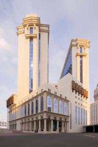 a building with two towers and a tall building at Hilton Hotel & Convention Jabal Omar Makkah in Mecca