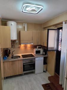 a small kitchen with a sink and a microwave at Casita La Playa in Málaga +55 photos