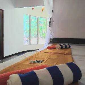 a bedroom with a bed with scissors and a window at gramatic dream cottage in Udawalawe