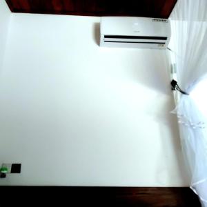a white wall with a heater on top of it at gramatic dream cottage in Udawalawe