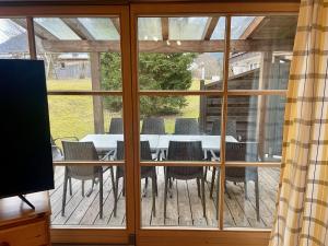 a patio with a table and chairs on a deck at Landhaus Maiergschwendt inkl Chiemgaukarte in Ruhpolding