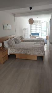 a bedroom with a large bed in a room at WATERS HOUSE STUDIO in Peniche