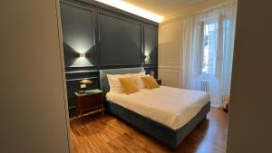 a bedroom with a bed with two yellow pillows at SalutieBaci in Lerici +23 photos