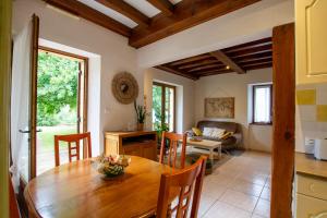 une cuisine et une salle à manger avec une table en bois dans l'établissement Le Baron Perché, à Saint-Cyprien
