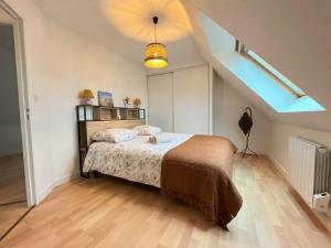 a bedroom with a bed and an attic at Maison des Dunes in Plougoulm