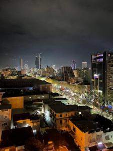 a view of a city at night with buildings at Garden Building Luxury Apartment in Tirana
