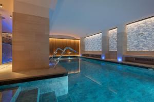 a large swimming pool in a hotel room with a swimming pool at Sangallo Palace in Perugia