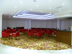 uma grande sala com cadeiras vermelhas e mesas em Shilla Hotel em Velimeşe