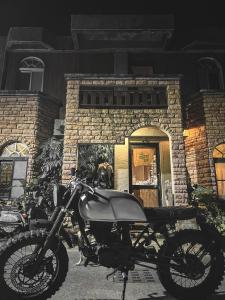 a motorcycle parked in front of a brick building at 旅兜- house in Lanyu