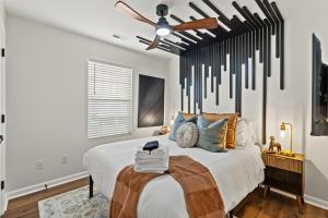 a bedroom with a bed with a ceiling fan at The Luxe Hot Tub Playground 12 Min to Horse Park in Georgetown +40 photos