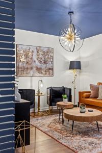 a living room with a couch and a table at The Luxe Hot Tub Playground 12 Min to Horse Park in Georgetown