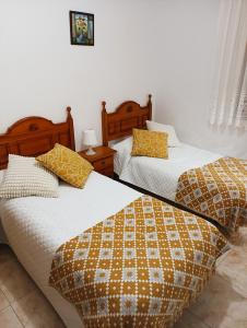 Postel nebo postele na pokoji v ubytování Hostal San José Naval