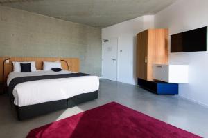 Voodi või voodid majutusasutuse Hôtel Belvue toas