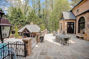an outdoor patio with a table and a gazebo at 9-Bedroom Atlanta Mansion for Rentals and Events in Marietta
