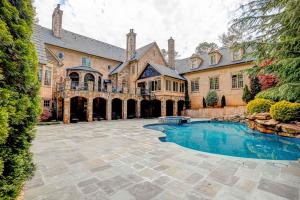 a large house with a swimming pool in the yard at 9-Bedroom Atlanta Mansion for Rentals and Events in Marietta