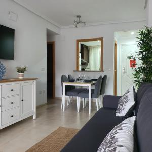 a living room with a couch and a table at Casa Dorada Primera Línea Oropesa in El Borseral