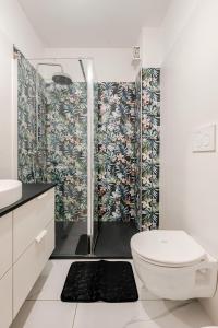 a bathroom with a toilet and a shower at Latina Modern Apartment in Latina +13 photos
