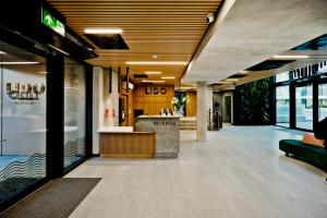 an empty lobby of a building with a counter at Hotel LIDO in Jurata +33 photos