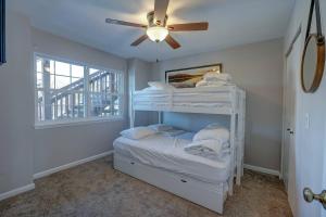 a bedroom with two bunk beds and a ceiling fan at Steps to Table Rock Lake, Min to Silver Dollar City in Branson +18 photos