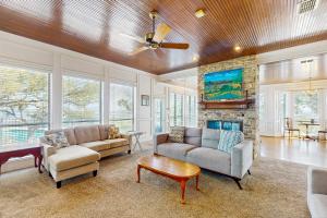 a living room with two couches and a fireplace at Maverick Mountaintop Retreat in Canyon Lake