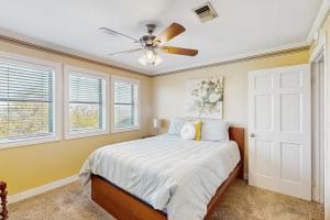 a bedroom with a bed and a ceiling fan at Maverick Mountaintop Retreat in Canyon Lake +22 photos