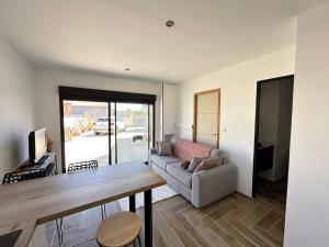 a living room with a table and a couch at Rubis in Lapalme