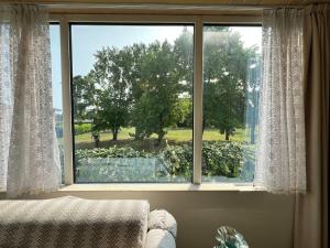 a large window with a view of a garden at Desenzano Lakeview - Luxury Flat in Desenzano del Garda