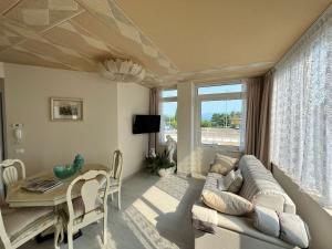a living room with a couch and a table at Desenzano Lakeview - Luxury Flat in Desenzano del Garda
