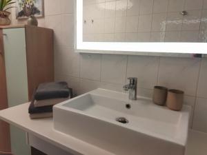 a white sink in a bathroom with a mirror at Ferienwohnung Familie Pohle in Lübbenau