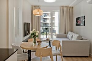 a living room with a couch and a table at Hotel LIDO in Jurata
