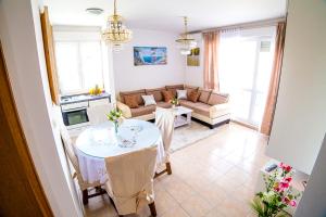 a living room with a table and a couch at Split Apartments Shell in Split +21 photos