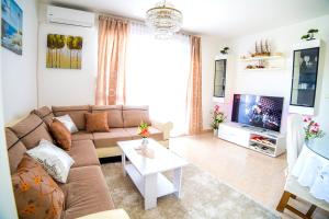a living room with a couch and a tv at Split Apartments Shell in Split