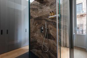 a bathroom with a shower with a glass door at G Cave 125 Boutique Apartment in Palermo +28 photos