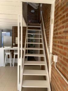 a staircase in a room with a brick wall at Depto Amonite Mar Caribe in Puerto Madryn