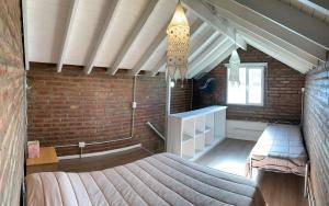 a bedroom with a bed and a brick wall at Depto Amonite Mar Caribe in Puerto Madryn