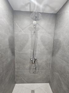 a shower with a shower head in a bathroom at Makenzy Mermaid 2 Bedroom Apartment in Larnaca +58 photos