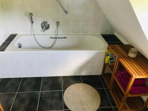 a bathroom with a bath tub with a shower at Ferienhaus Thalblick in Ruhla in Ruhla