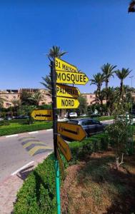 a street sign with many signs on a road at JackRouivo in Marrakech +11 photos