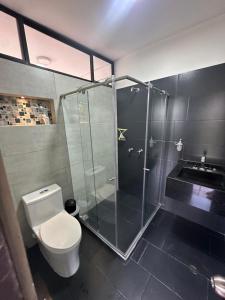 a bathroom with a shower and a toilet and a sink at Cabaña La Isabelita in Chinácota