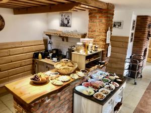 a kitchen with a bunch of food on a counter at Gościna u Maryny & SPA pod Tatrami in Poronin