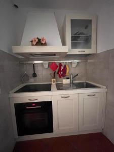 a kitchen with white cabinets and a sink at CharmandView Assisi in Assisi +28 photos