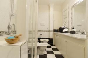 a white bathroom with a toilet and a sink at Domus Dea in Venice