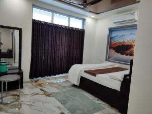 Krevet ili kreveti u jedinici u okviru objekta Rivaidhii inn rooms
