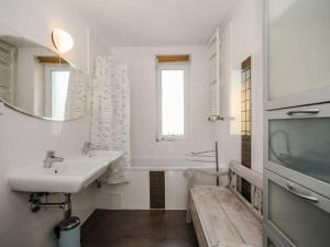 a bathroom with a sink and a toilet and a tv at Willa Róż Wisełka in Wisełka +34 photos